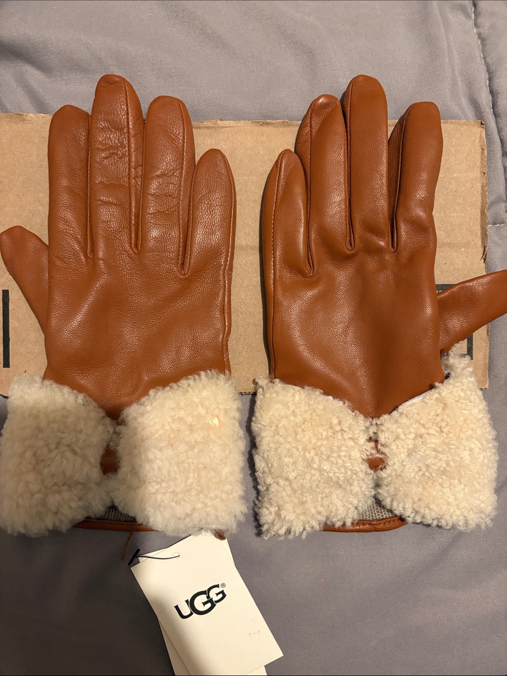 UGG Tan Leather Gloves with Cream Shearling Cuff. Fit is more like a small.